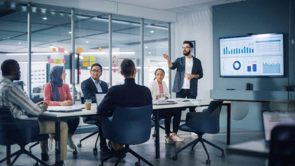 Startup team discussing strategy and analyzing data during a collaborative meeting.